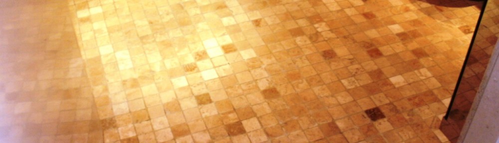 Cleaning a Tumbled Marble mosaic wet room floor in London SE1